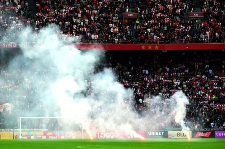 Ajax-Feyenoord abandoned after flares lobbed on pitch