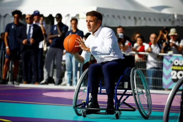 Macron takes to wheelchair to urge French to support 2024 Paralympics