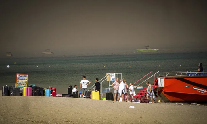 A wildfire is raging out of control on the Greek island of Rhodes, forcing tourist evacuations