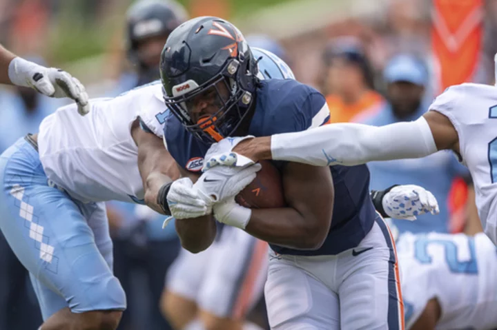 Virginia player wounded in deadly attack returns for a new season as an inspiration to his teammates