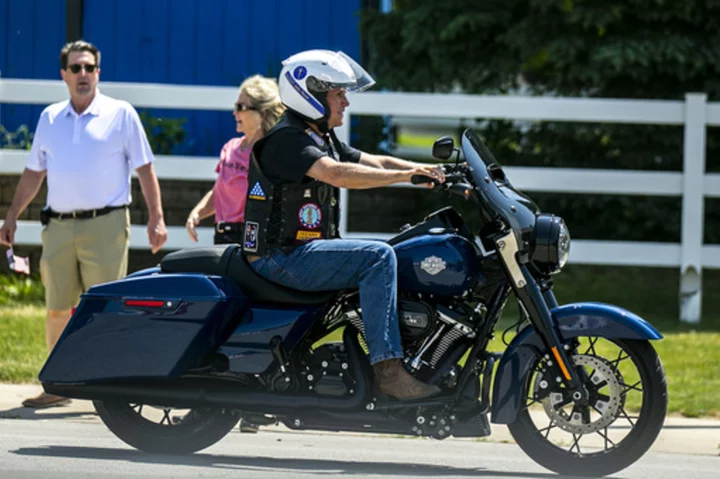 DeSantis signs Bible, Pence hops on motorcycle at 'Roast and Ride' rally in Iowa