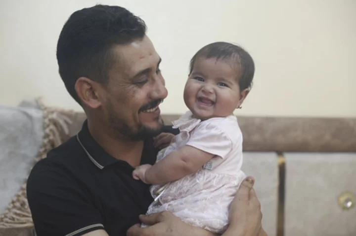 Syrian baby born under earthquake rubble turns 6 months, happily surrounded by her adopted family