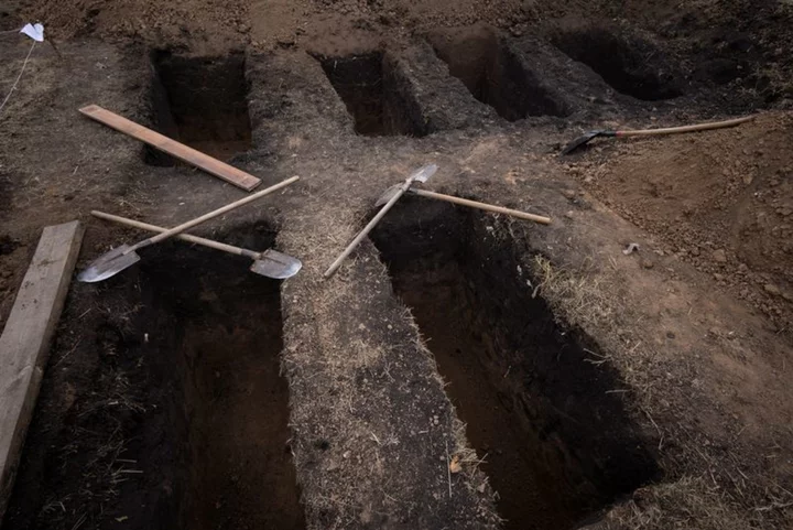 Ukrainian villagers weep as they bury victims of Hroza missile strike