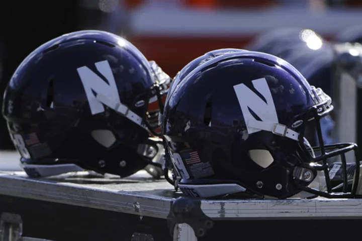 Northwestern football staffers wear shirts in support of fired coach Pat Fitzgerald at practice