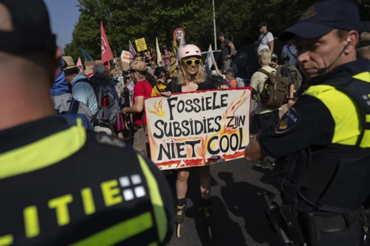 Climate protesters have blocked a Dutch highway to demand an end to big subsidies for fossil fuels