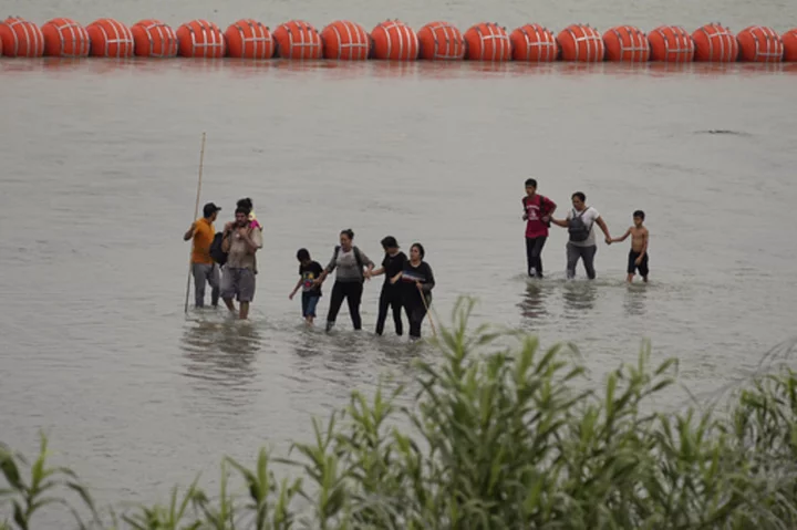 Biden administration sues Texas governor over Rio Grande buoy barrier that’s meant to stop migrants