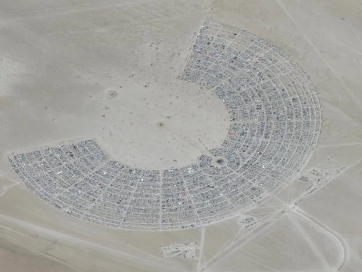 Tens of thousands at Burning Man told to conserve water and food after heavy rains leave attendees unable to leave Nevada desert