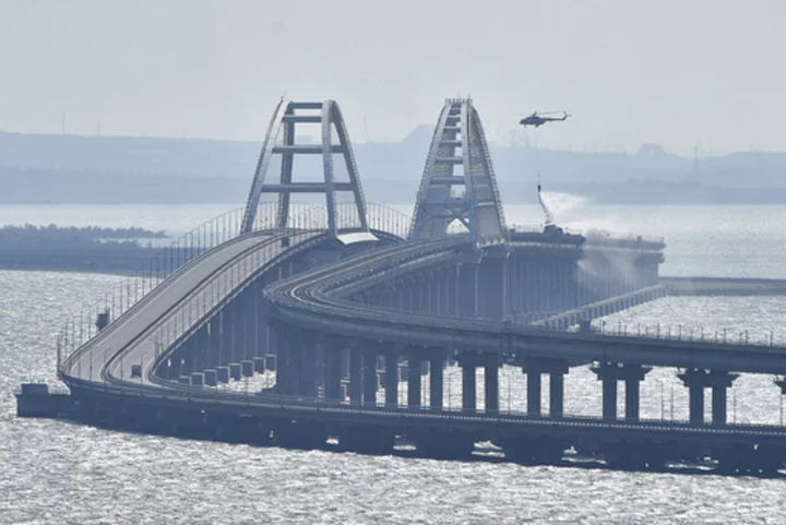 Traffic on key bridge connecting Crimea to Russia's mainland halted amid reports of explosions