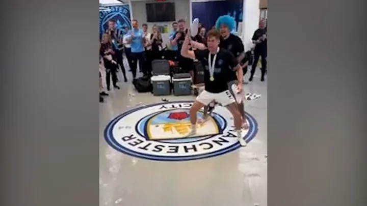 Jack Grealish panics as his £1,730 bag almost falls victim to Man City's changing room celebrations