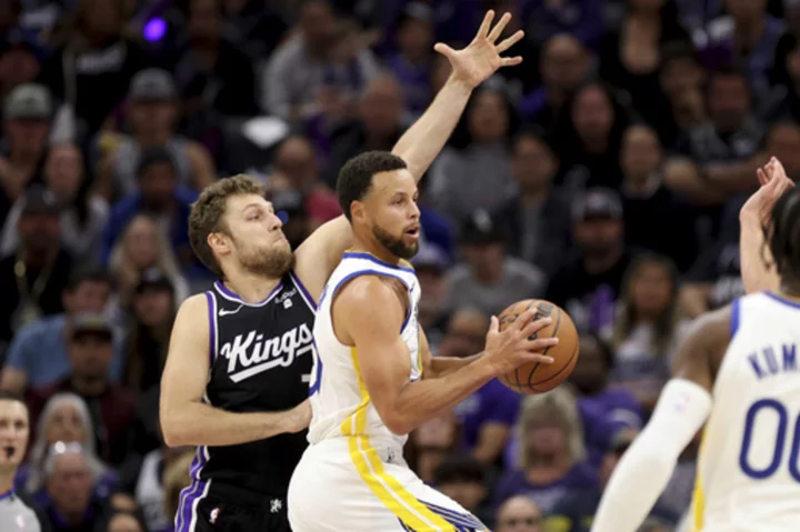 Curry scores 41 points to lead the Warriors past the Kings 122-114 in a playoff rematch