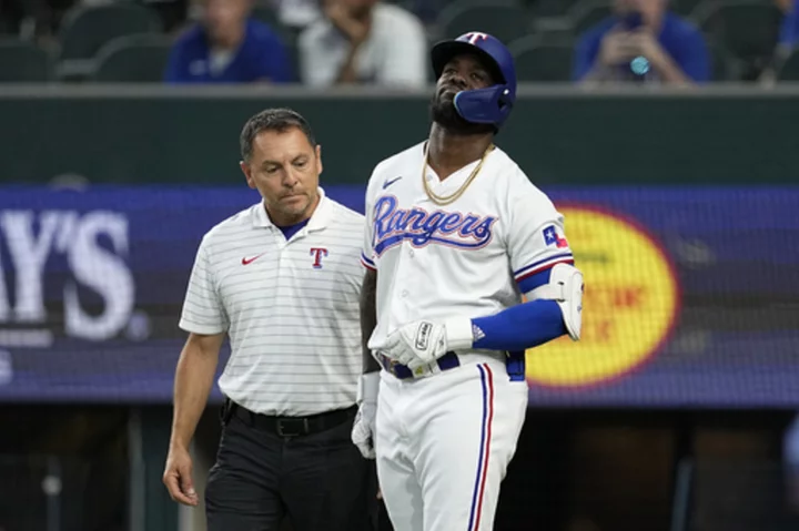 Rangers slugger Adolis García, leading the AL in RBIs, exits game after getting hit by a pitch