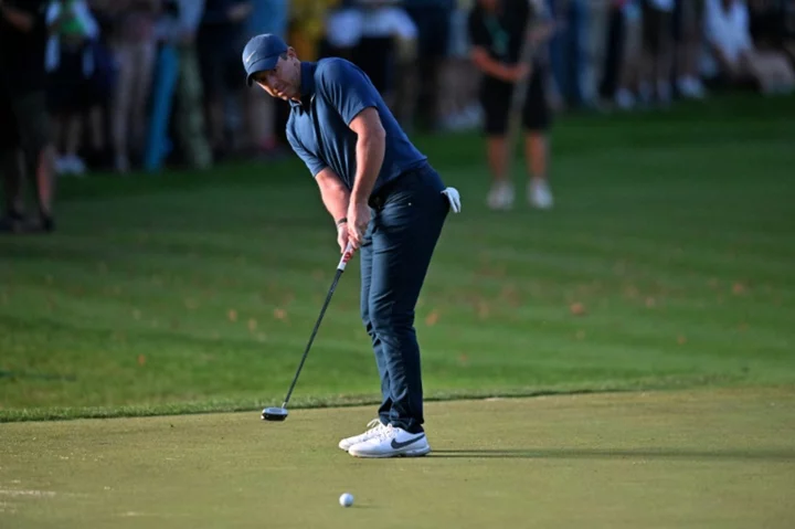 McIlroy's closing birdie keeps Wentworth cut bid alive amid fan clashes