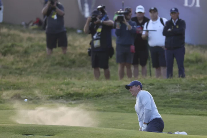 Bunker save at the last hole helps McIlroy stay alive at British Open
