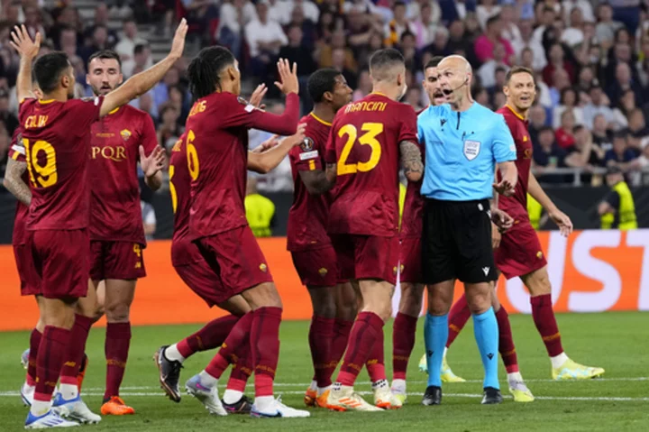 Europa League final referee Taylor and family surrounded by hostile Roma fans at airport