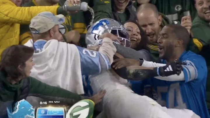 Packers Fan Pours Beer on Amon-Ra St. Brown During Lambeau Leap With Lions Fans