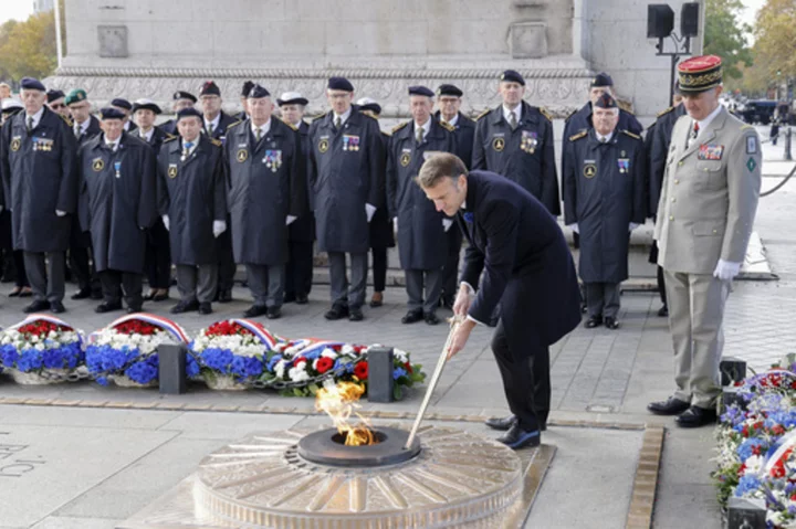 Somber bugles and bells mark Armistice Day around the globe as wars drown out peace messages