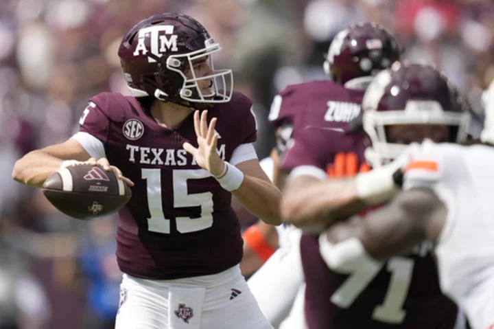 Johnson throws 2 TD passes after Weigman injured to lead Texas A&M to 27-10 win over Auburn